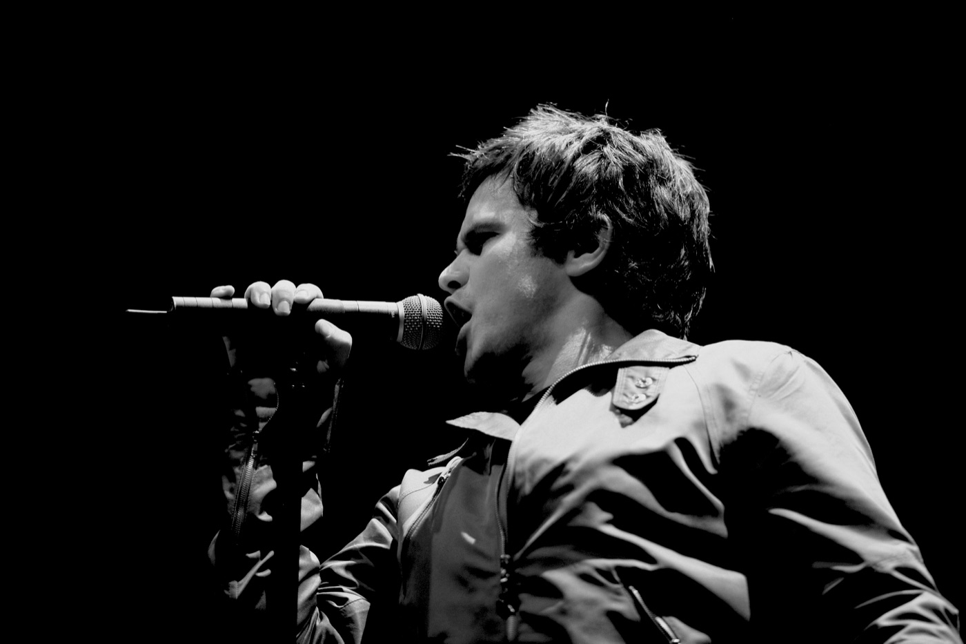 FMOF singing into a microphone